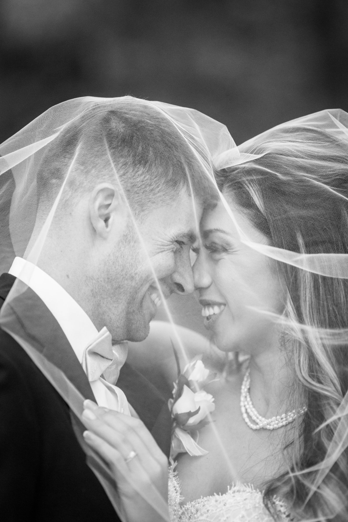 bride and groom kissing under veil in savannah