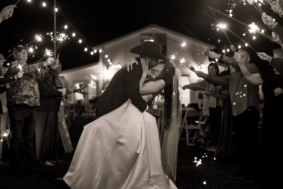 couple kissing during a sparkler exit at their wedding in Jacksonville Florida