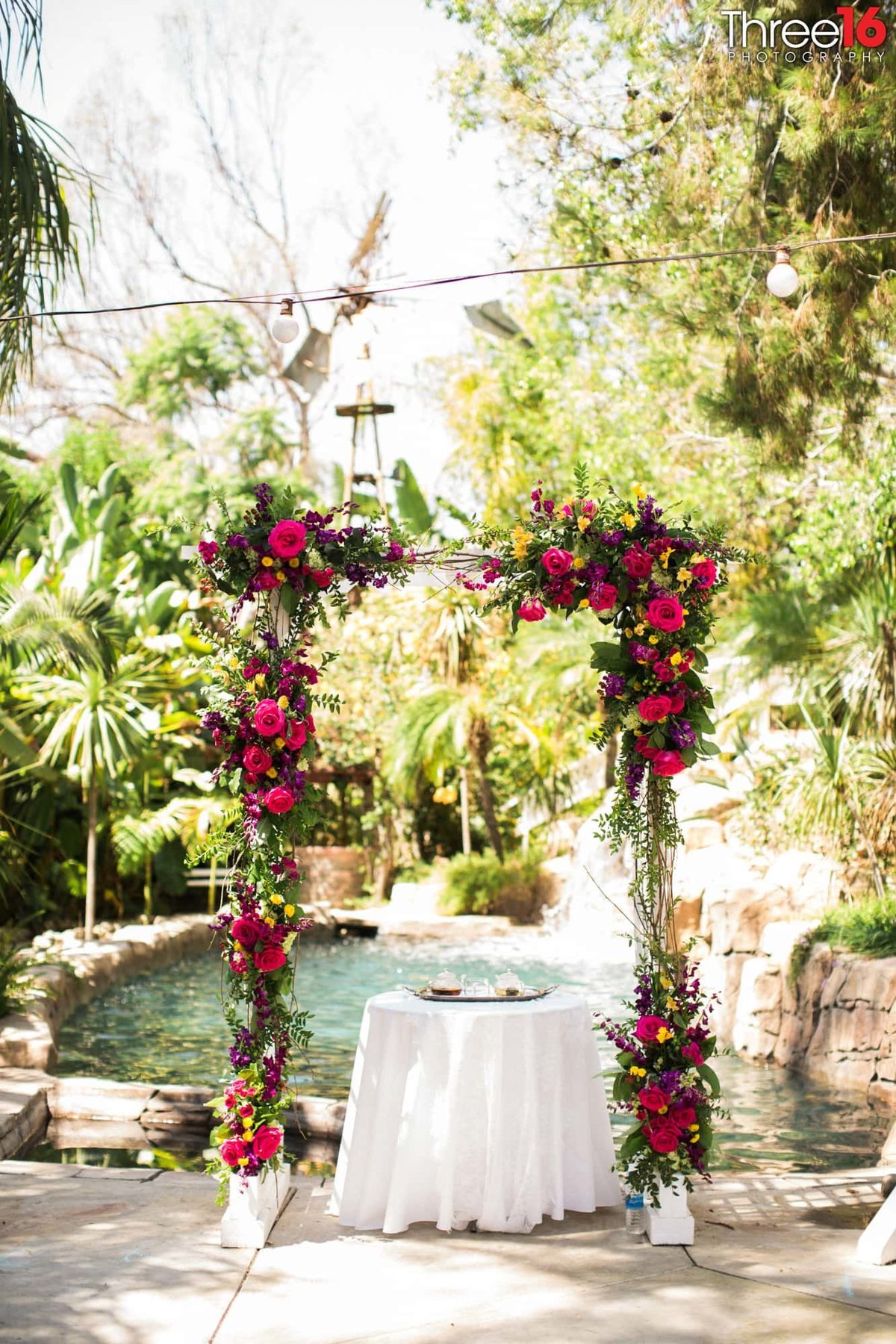 Floral archway over the sweetheart table at wedding reception