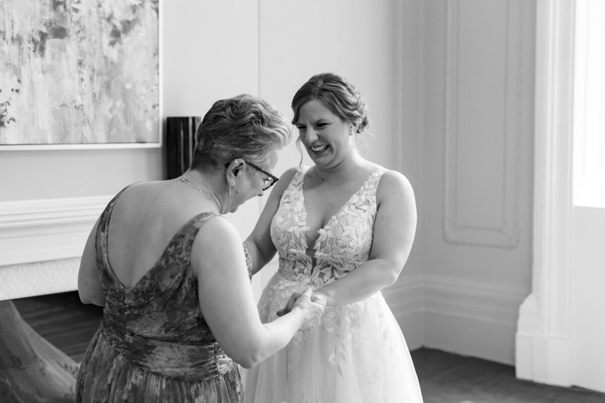 Bride holding hands with mother at  at Halifax Club wedding in Nova Scotia