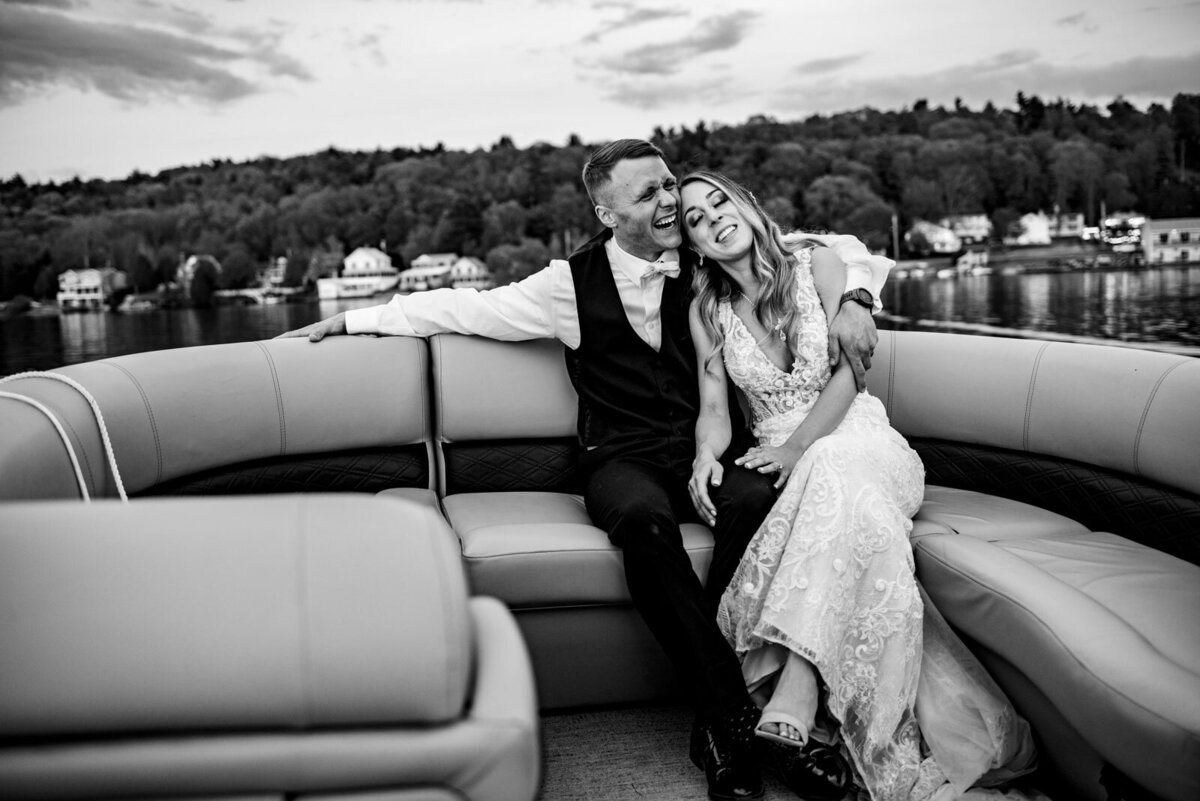 black and white portrait of bride and groom on boat at lake bomoseen lodge wedding