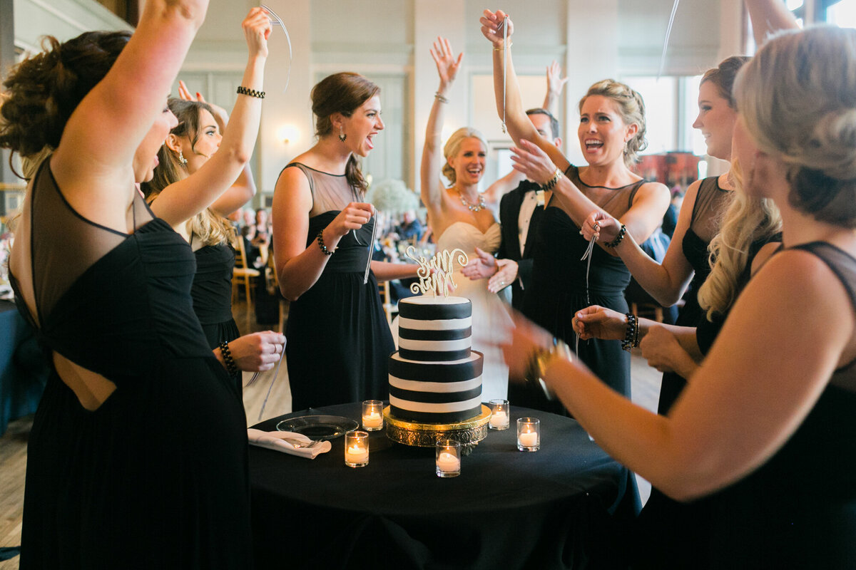 Bridesmaids share a candid moment together during the wedding reception