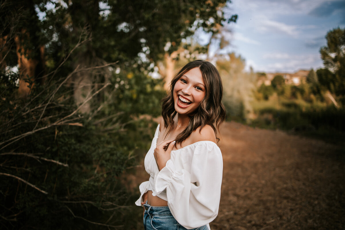girl laughs during senior session at holden hour in thornton colorado
