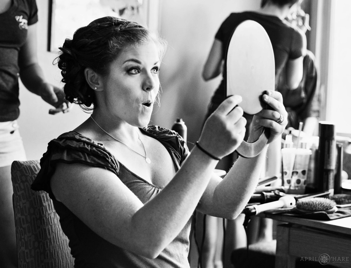Bridesmaid loves her make up looking in mirror at Wedgewood Mountain View Ranch in Pine CO