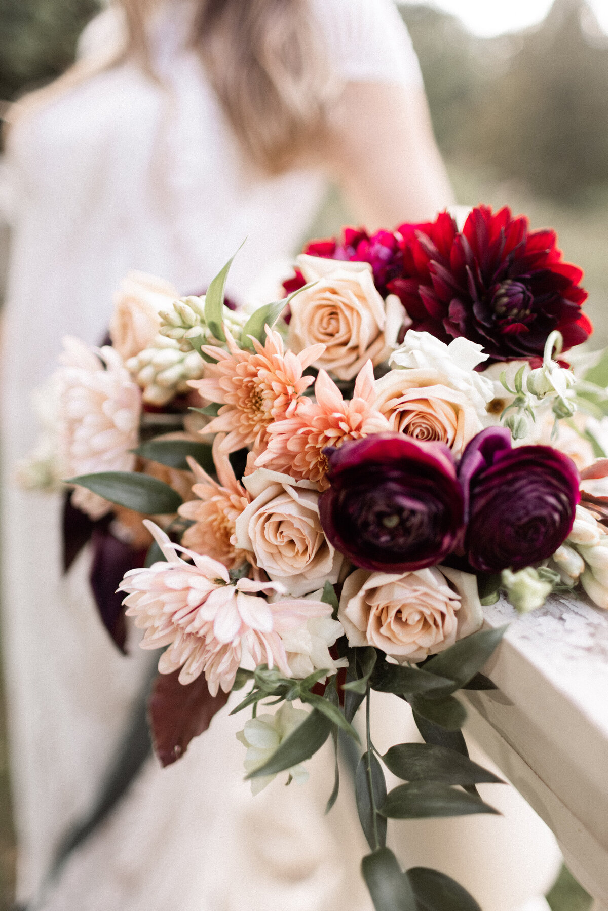A bridal bouquet of dahlias, roses, chrysanthemums and tuberose in autumn colors