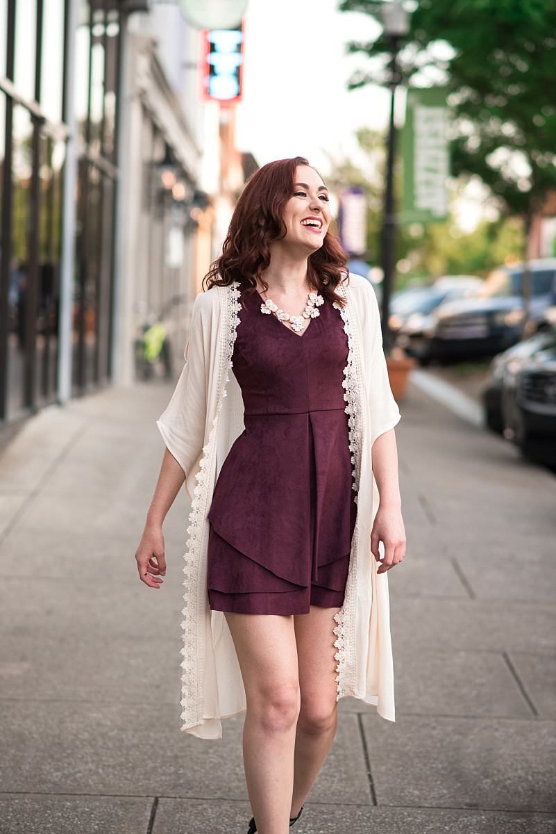 Short Maroon velvet dress and long cream duster being modeled on the Square in downtown Murfreesboro