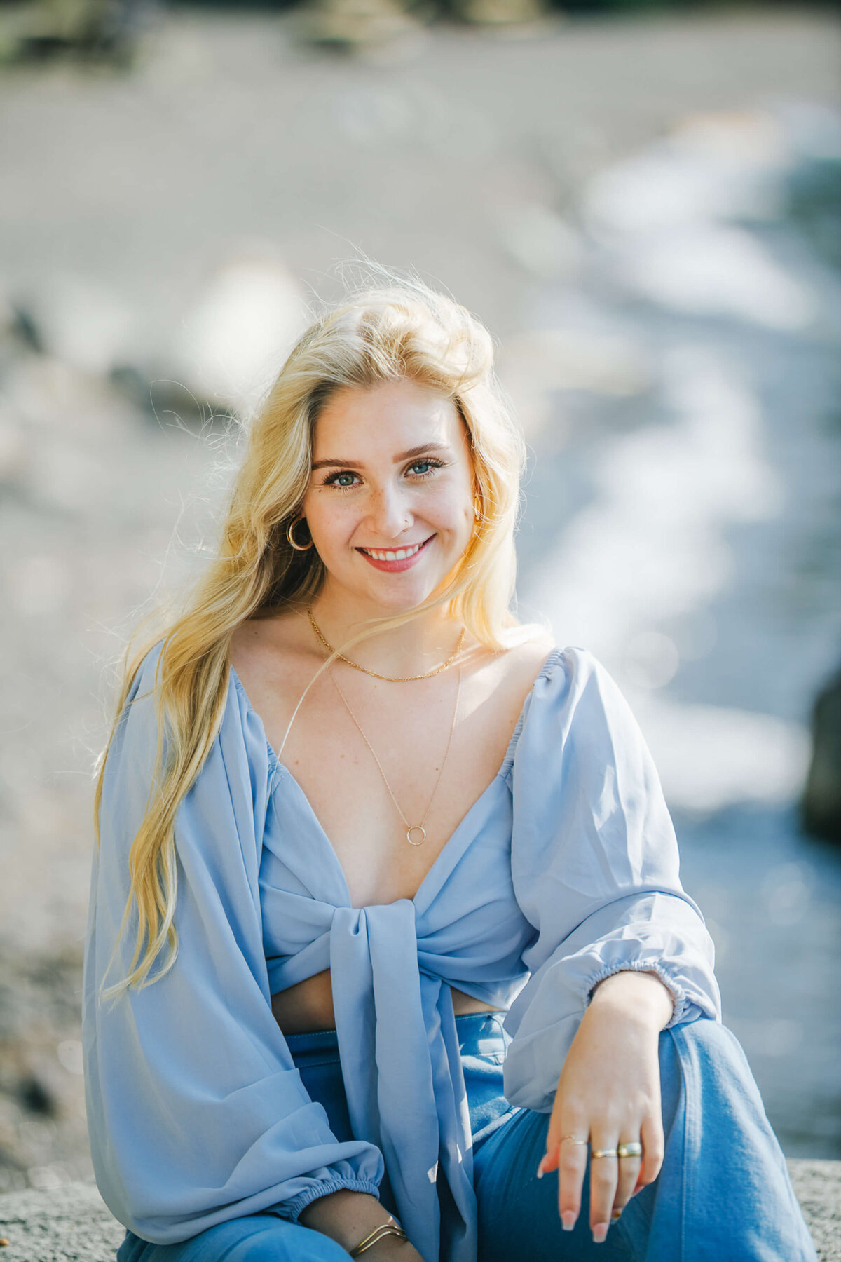 Senior smiling at camera in blue top in lake tahoe
