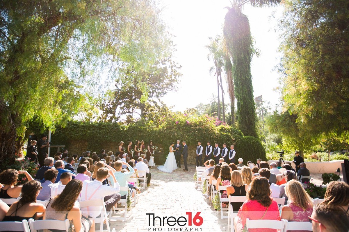 Outdoor wedding ceremony in action at the Rancho Buena Vista Adobe wedding venue in Vista, CA