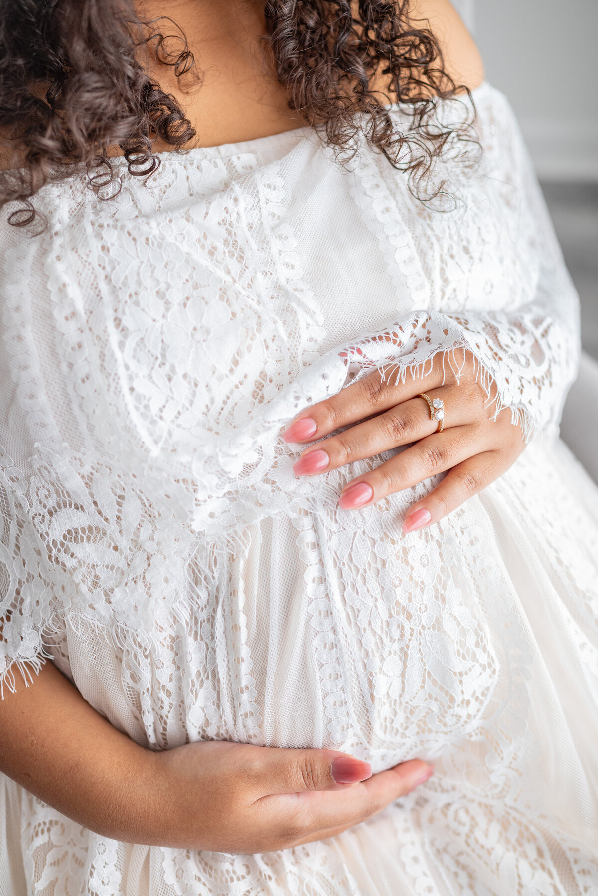 A close up picture of a mother cradling her stomach