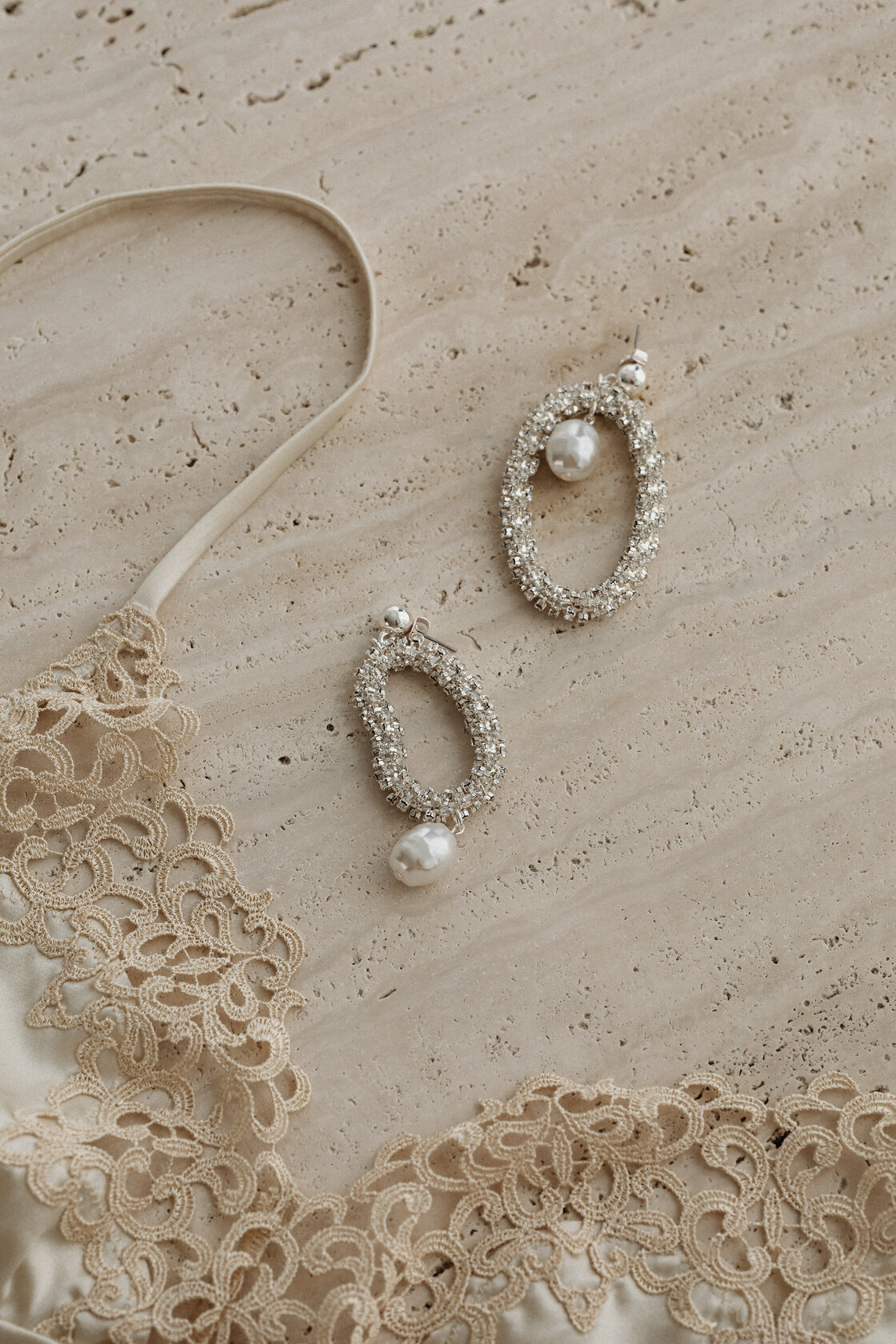 kaboompics_satin-light-beige-bra-trimmed-with-lace-silver-earrings-with-zircons-and-pearls-31788