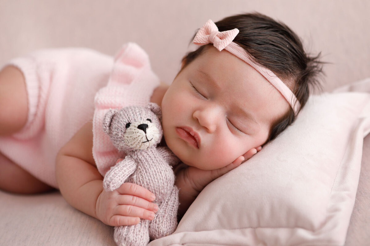 Newborn-photography-session-newborn-in-pink-outfit-with-pink-headband-and-teddy,-photo-taken-by-Janina-Botha-photographer-in-Oakville-Ontario