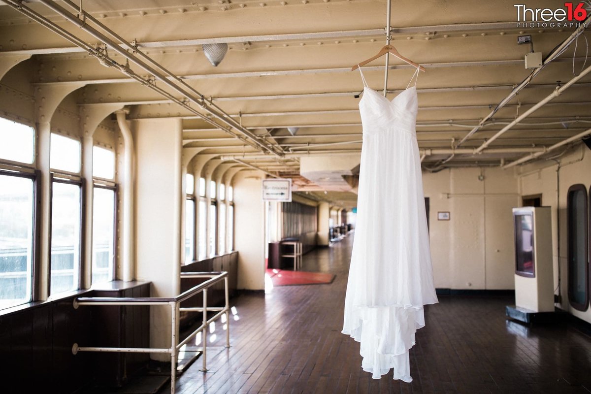 Brides wedding gown hanging from the Queen Mary