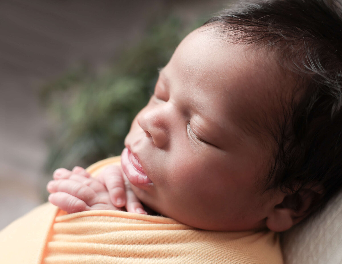 Side view of a newborn boy at our studio.