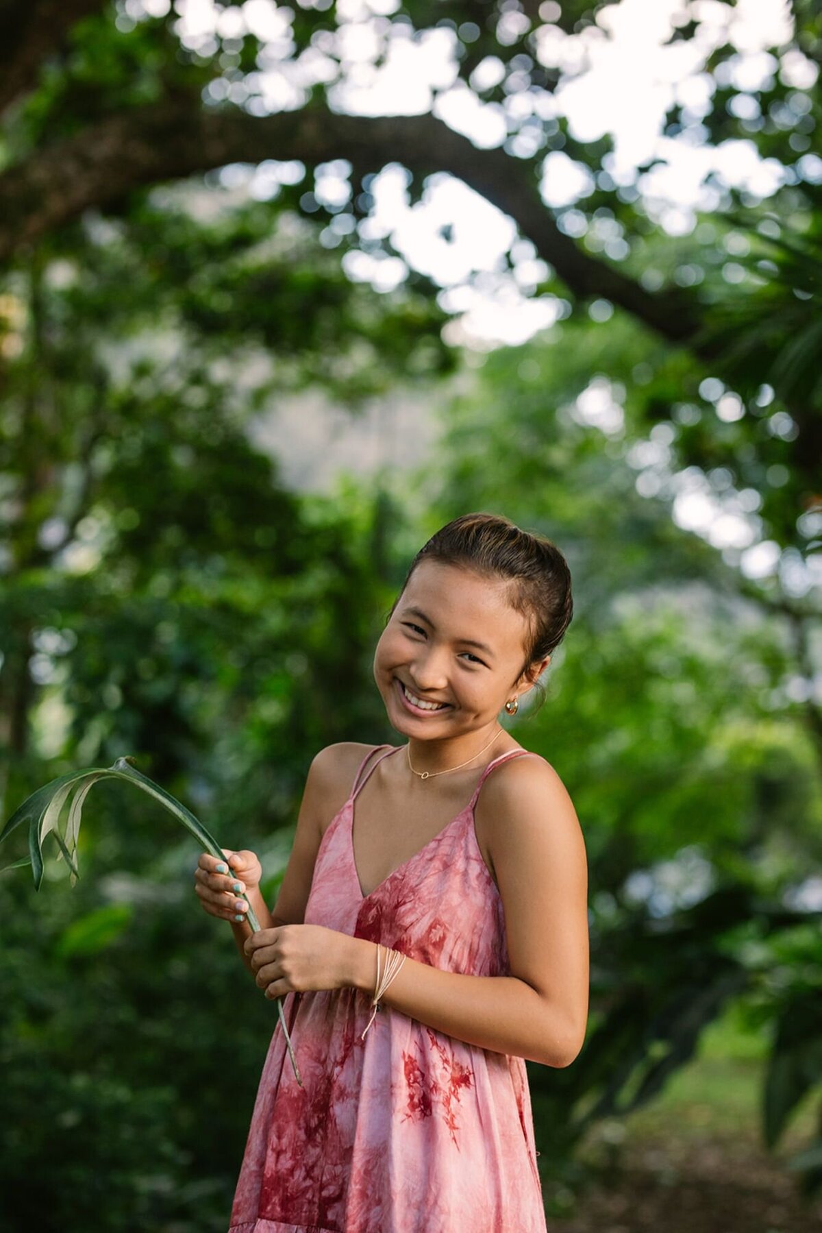 teen girl laughing during a photo shoot at nuuanu park