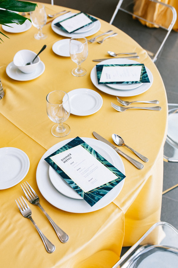Tropical Themed Table Setup with Yellow Linens at The Grand Rapids Art Museum Wedding Venue