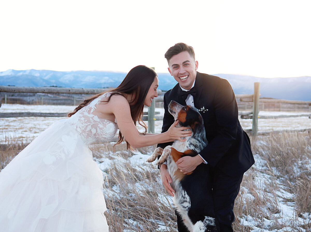 Bride and groom hugging their cute dog, just after they said their vows.