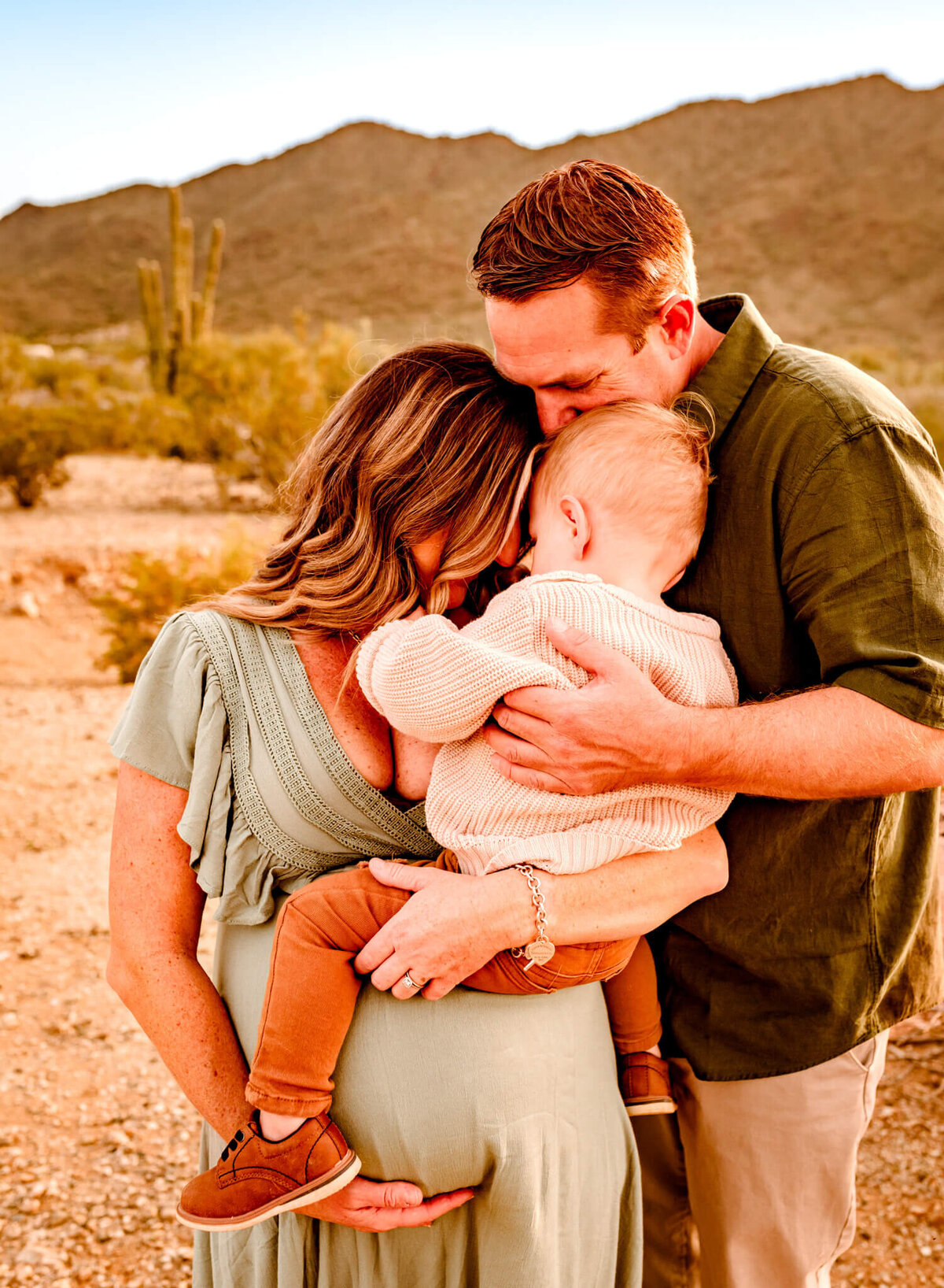 Arizona family hugging baby bump during maternity session with photographer Amber