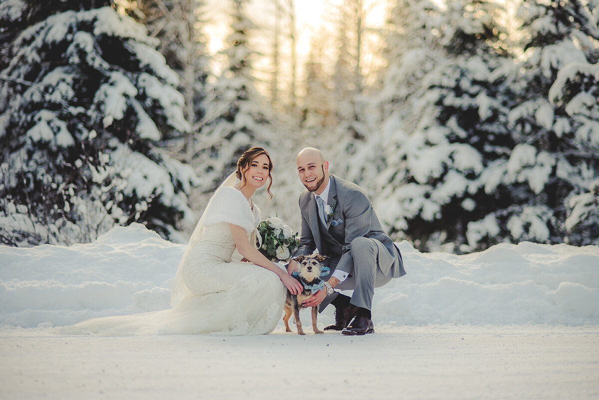 bride groom and dog in snow