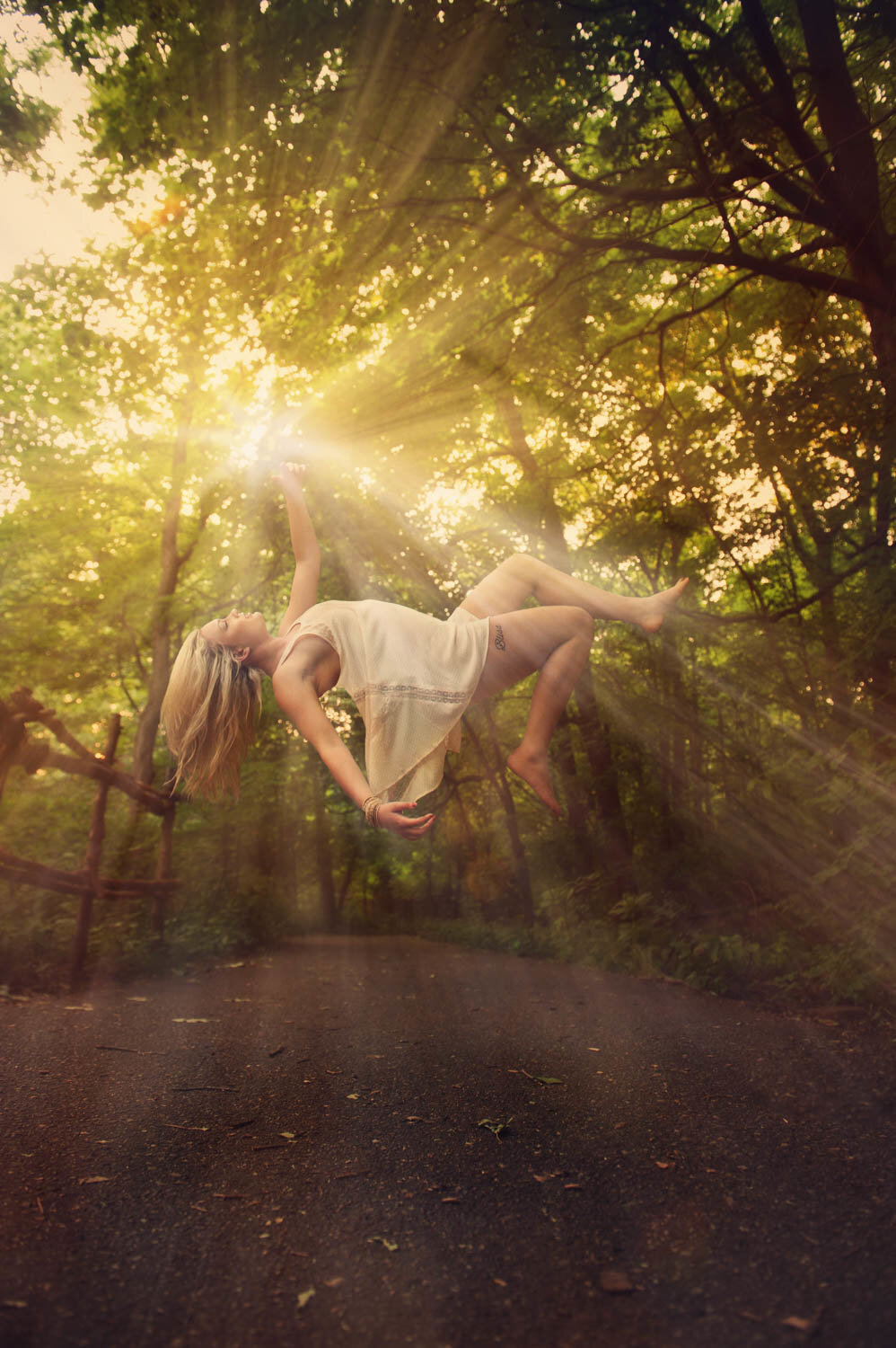 levitation image of girl in sunlight in trees