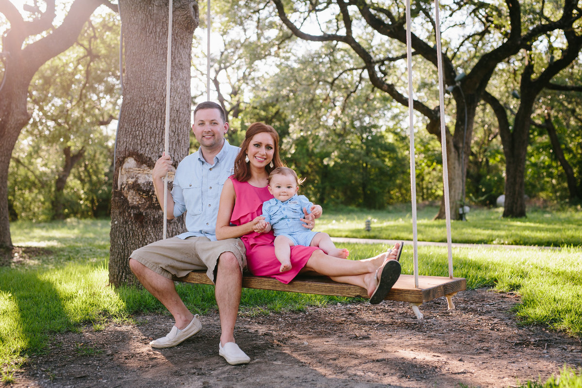 family photography sitting under a big tree on a swing by San Antonio Photographer Expose The Heart