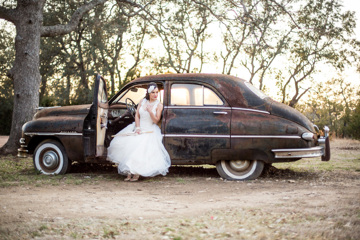 Bride sitting in vintage car at Vista West Ranch wedding venue by San Antonio Wedding photographer Expose The Heart