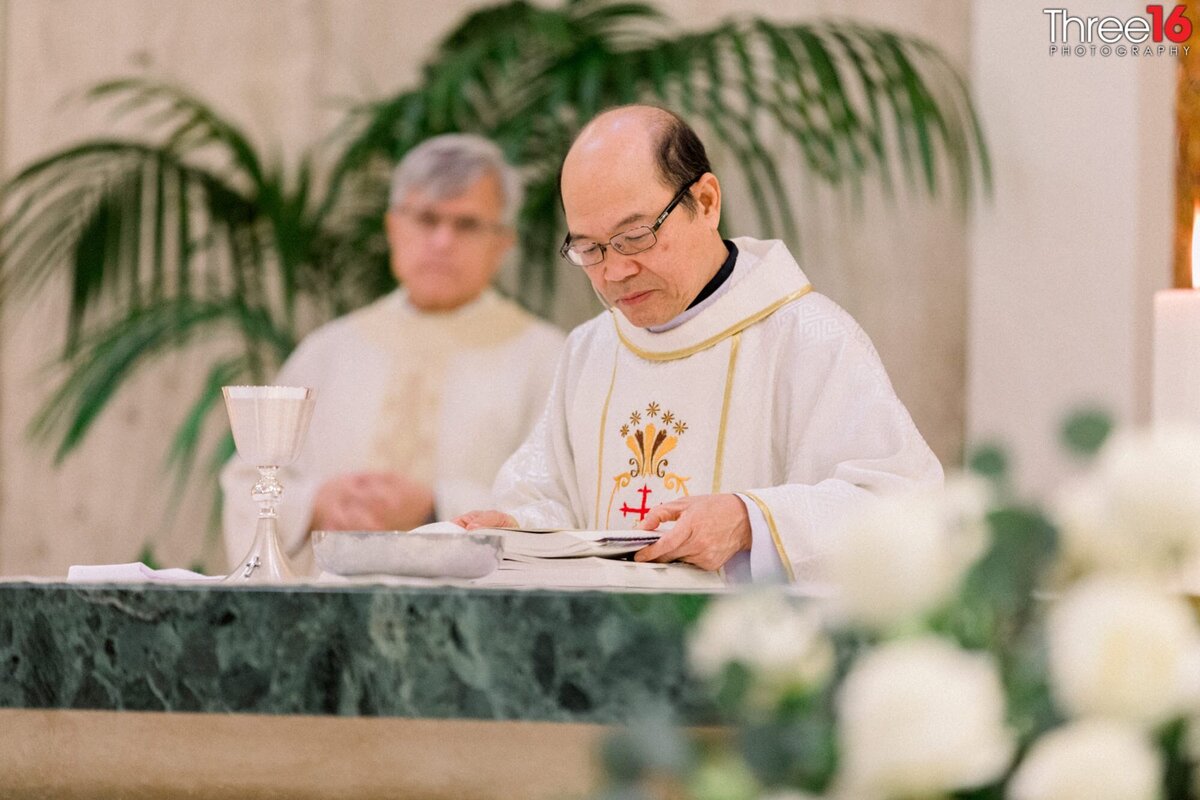Priest does a reading during a Catholic wedding ceremony