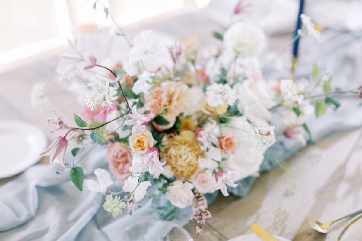 floral arrangement on a table at a Calgary wedding reception designed by Julianne Young weddings and photographed by Calgary wedding photographers David and Breanne Heidrich