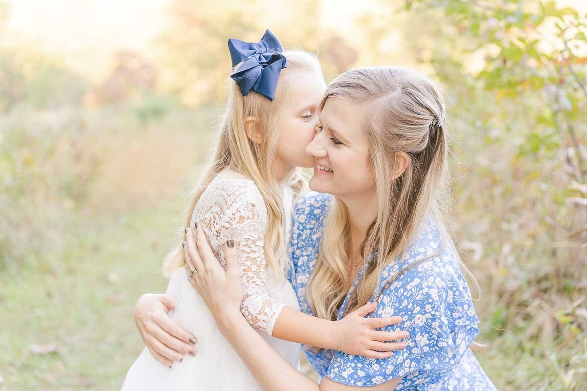 daughter kissing mom during fall minis in Fairfax, VA