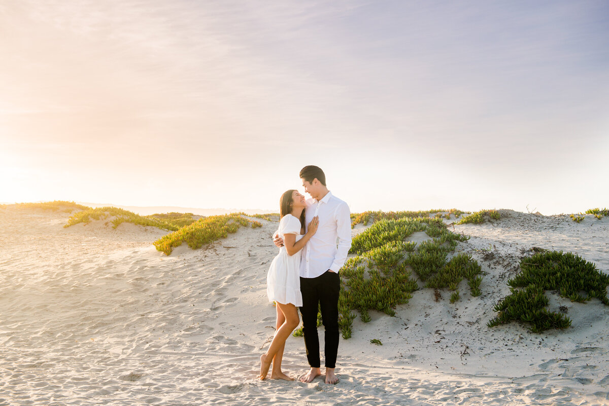 romantic moment between couple during engagement session in coronado san diego by photographer mattie taylor