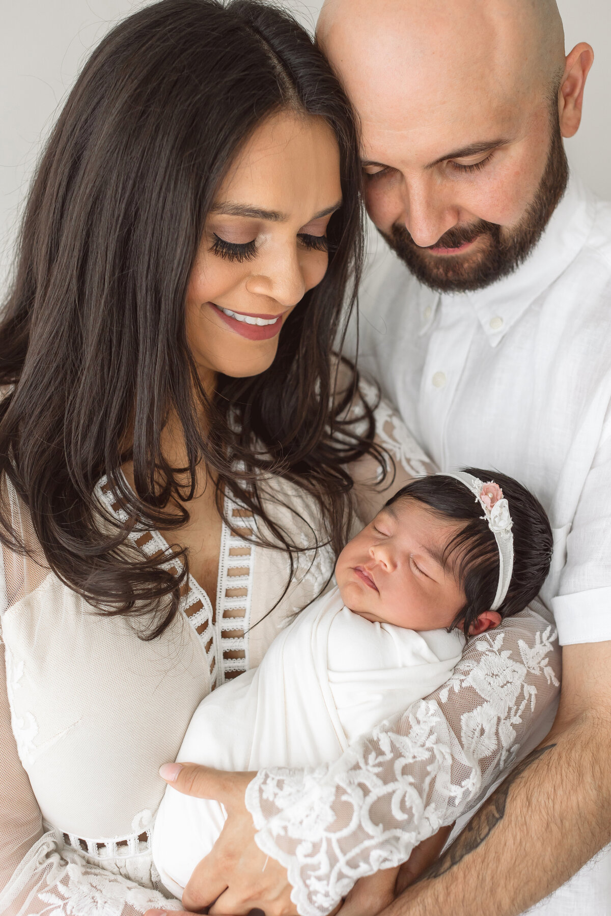 mother and father looking down on baby