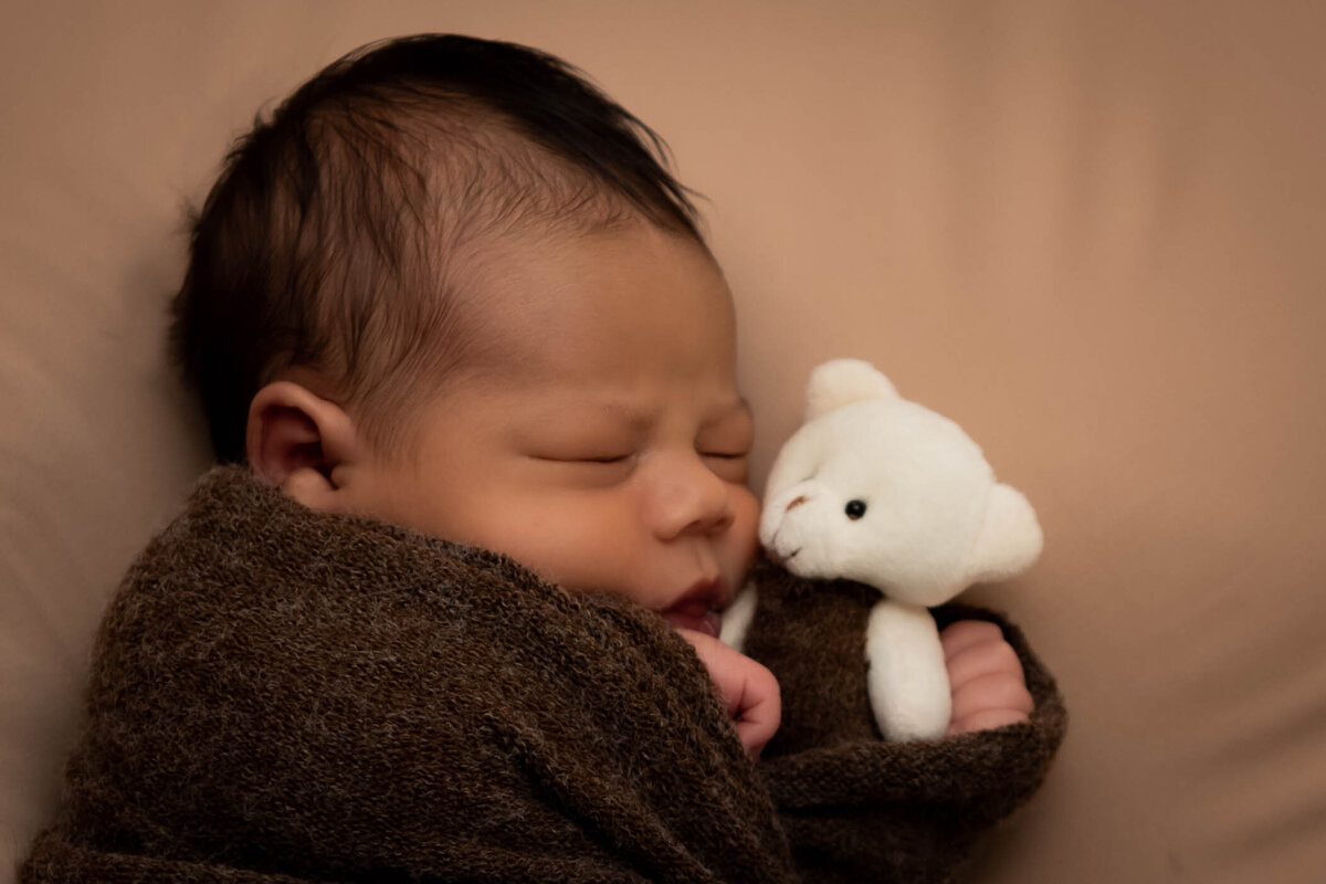 Newborn suished with favorite toy