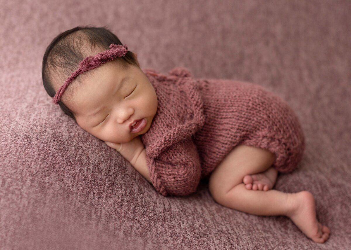 Newborn girl on a pink blanket