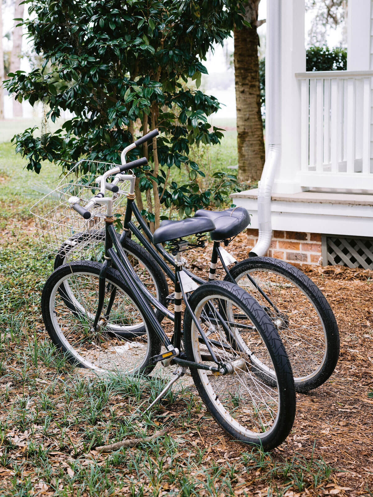 Two bicycles parked in front of a house in Montage at Palmetto Bluff. Destination wedding image by Jenny Fu Studio