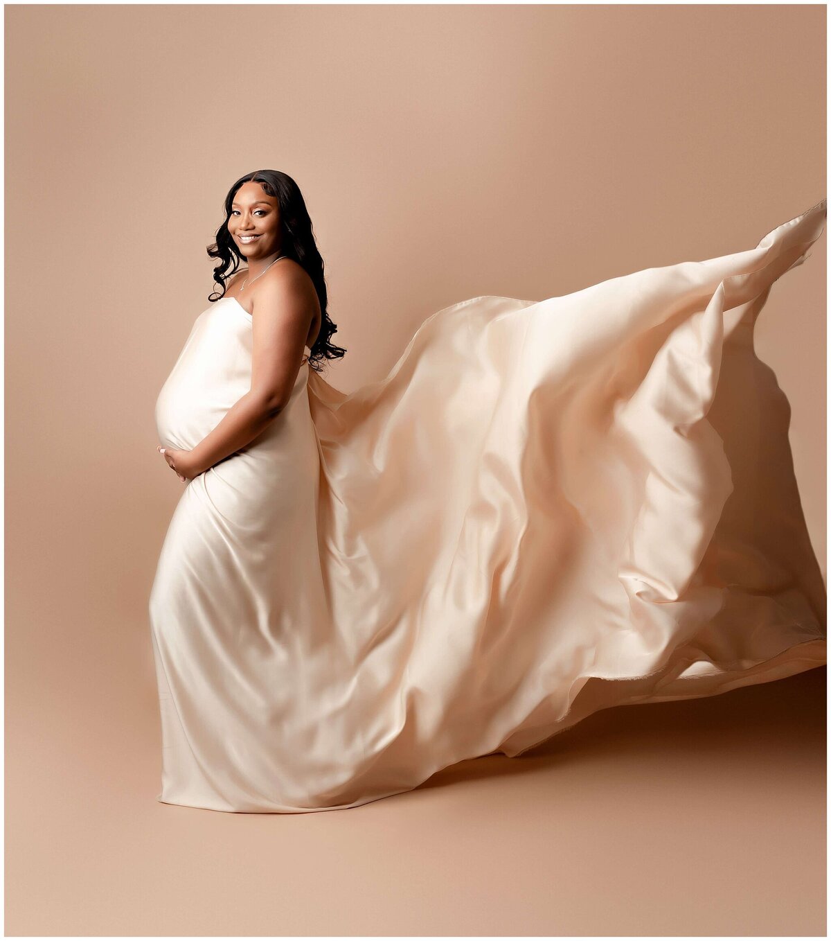 Studio maternity session in brooklyn fabric toss behind mom