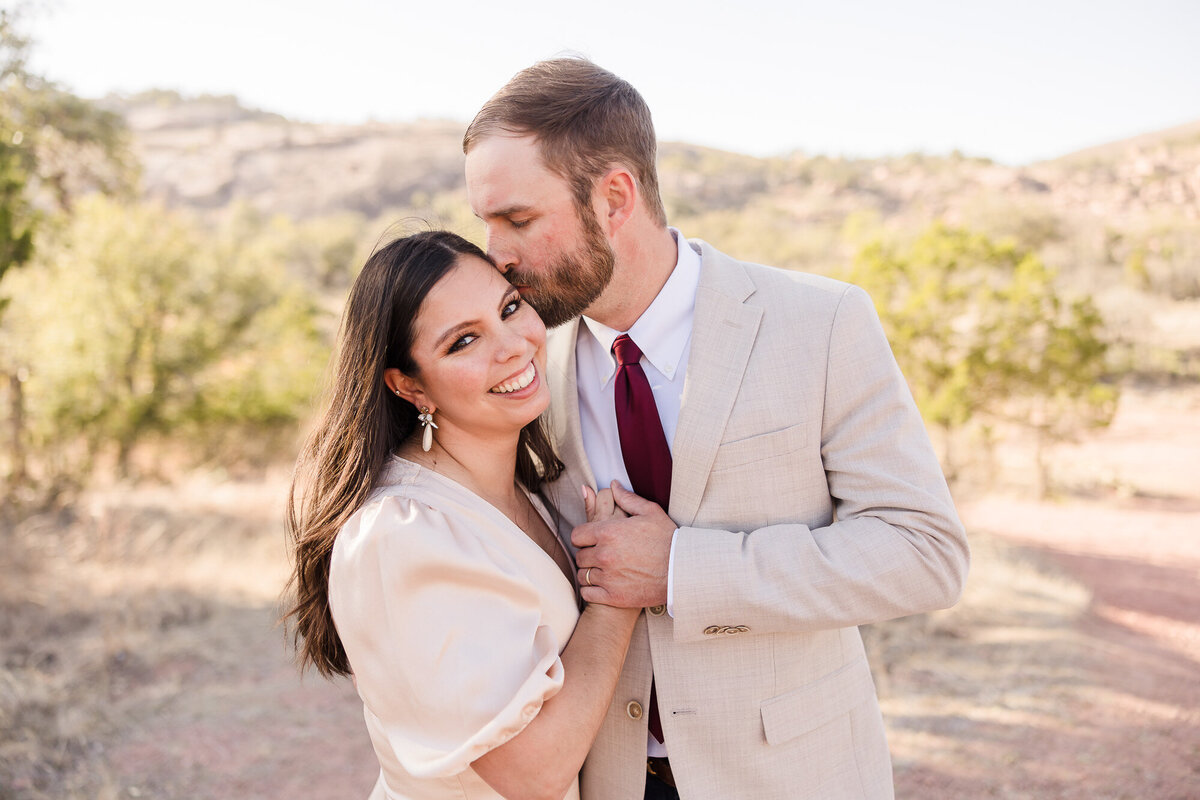 Couple enjoy their engagement session at Enchanted Rock in Fredericksburg, Texas
