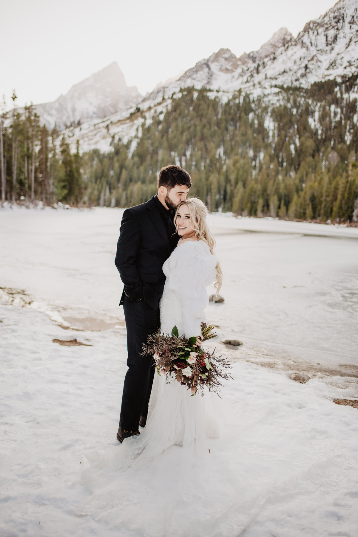 Jackson Hole Photographers capture groom kissing bride's head