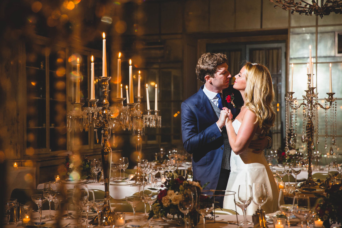 The bride and groom at Babington house after the wedding ceremony in the reception venue giving each other a kiss