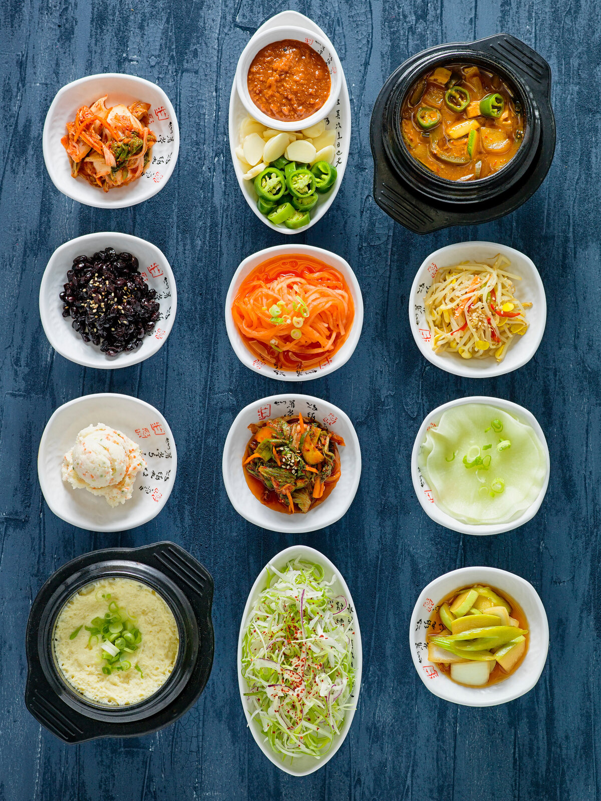 Various soups and side dishes laid out together