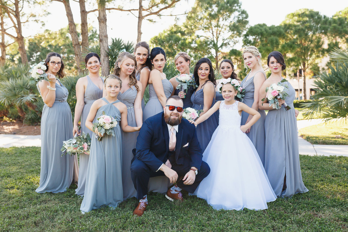 Bridesmaids Pose with the Groom During Their Tampa Bay Florida Wedding Photo Shoot