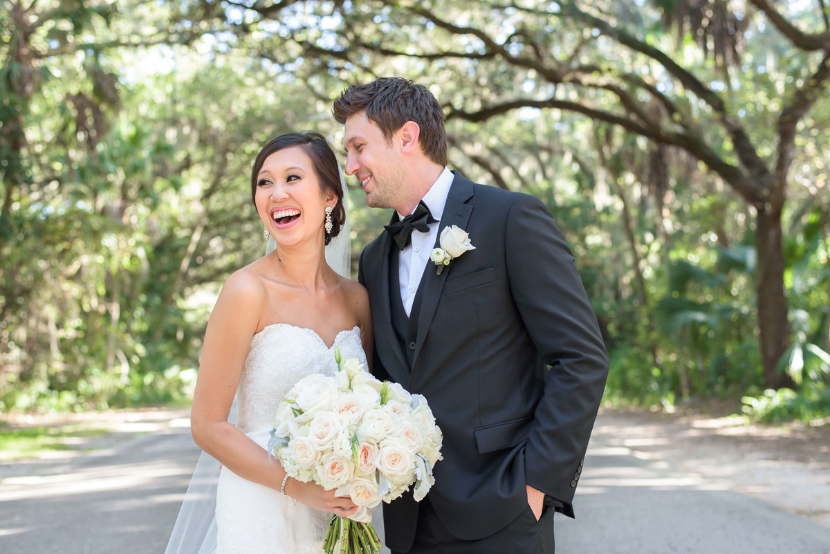 The Bride and Groom share a laugh under an oak lined street in Dunedin, Florida