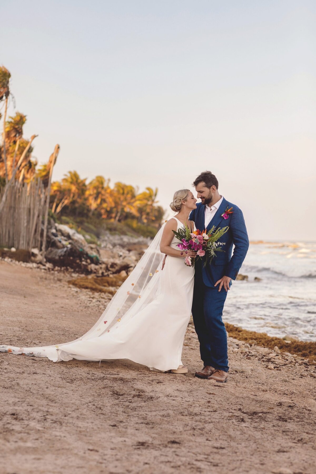 Bride and groom on beach at Blue Venado Seaside Riviera Maya wedding