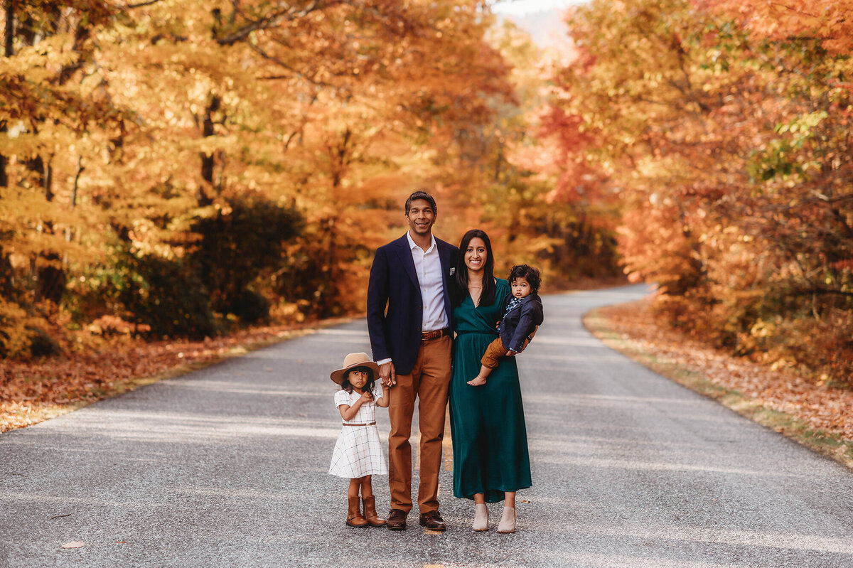 Family poses for portraits during Family Photoshoot on the Blue Ridge Parkway in Asheville, NC.