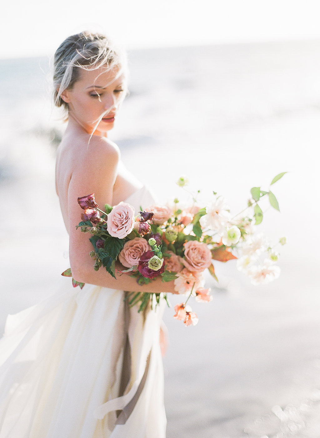bride holding bouquet at malibu beach