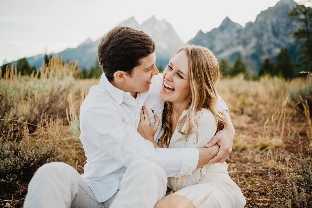 Photographers Jackson Hole capture couple laughing during Tetons engagements