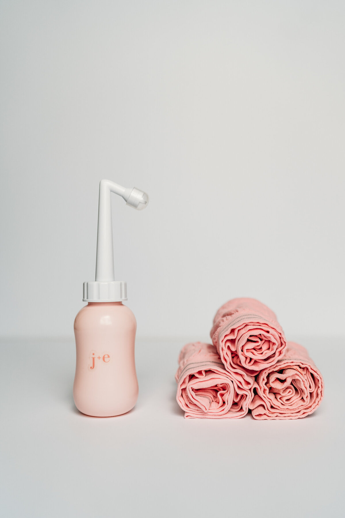 product shot of pink peri bottle and pink underwear