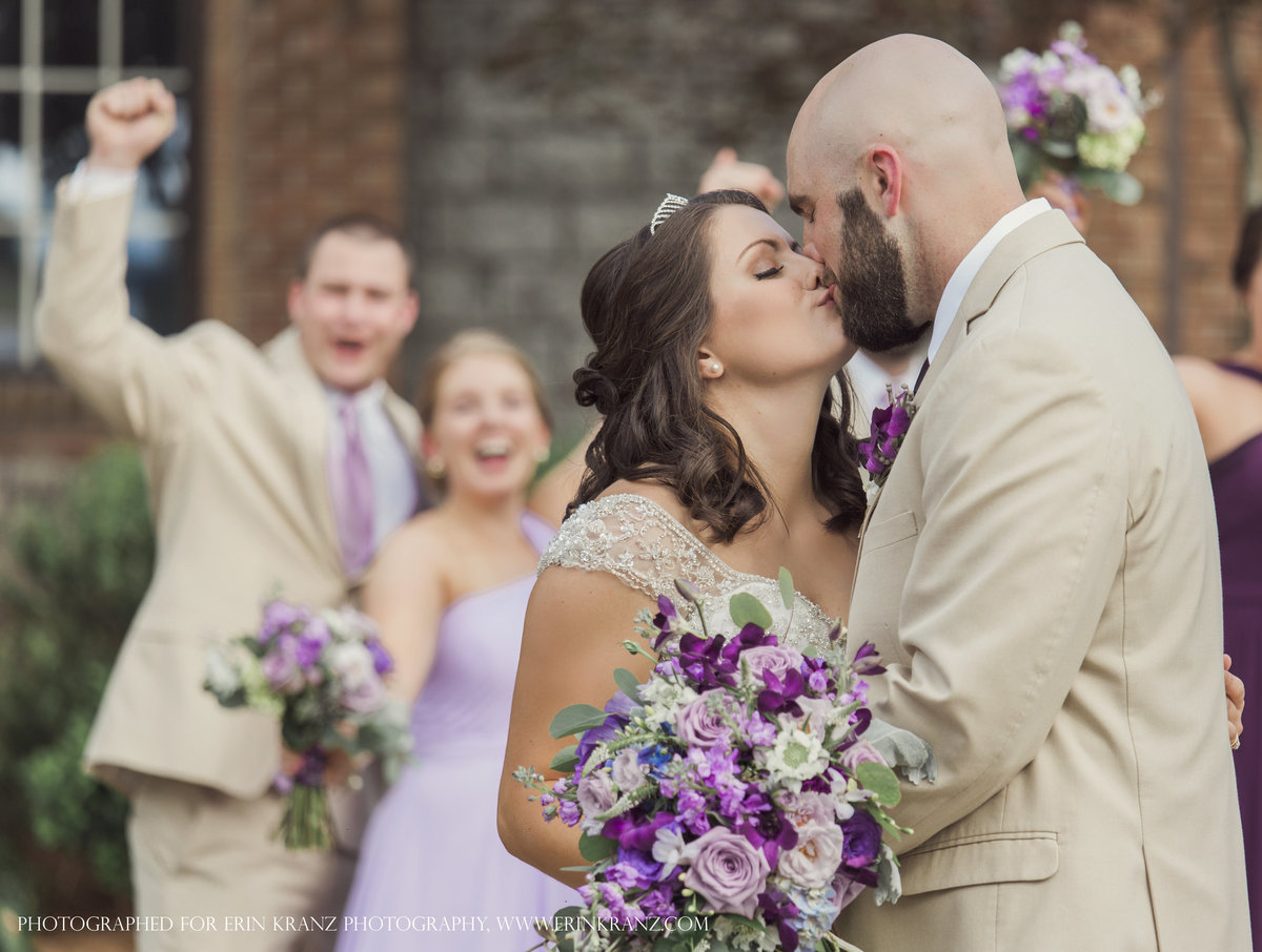 charlotte wedding photographer jamie lucido captures the bride and groom kissing in front of the castle at Barclay Villa in Raleigh North Carolina