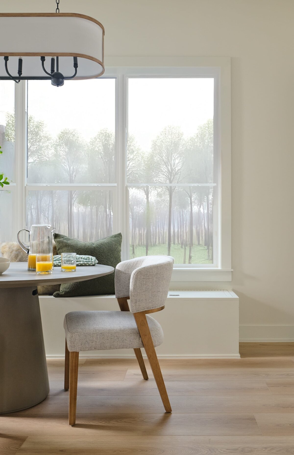 cocoloba homes graham dining room table with window bench and pillows
