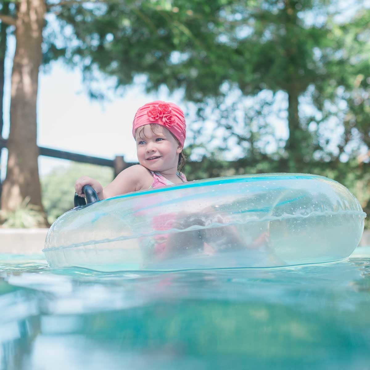 little girl floating in raft at Castle Pines Resort in Texas