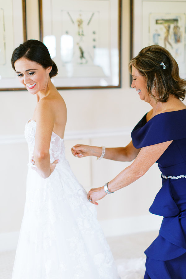 Bride-Getting-In-Gown-Mother-Helping