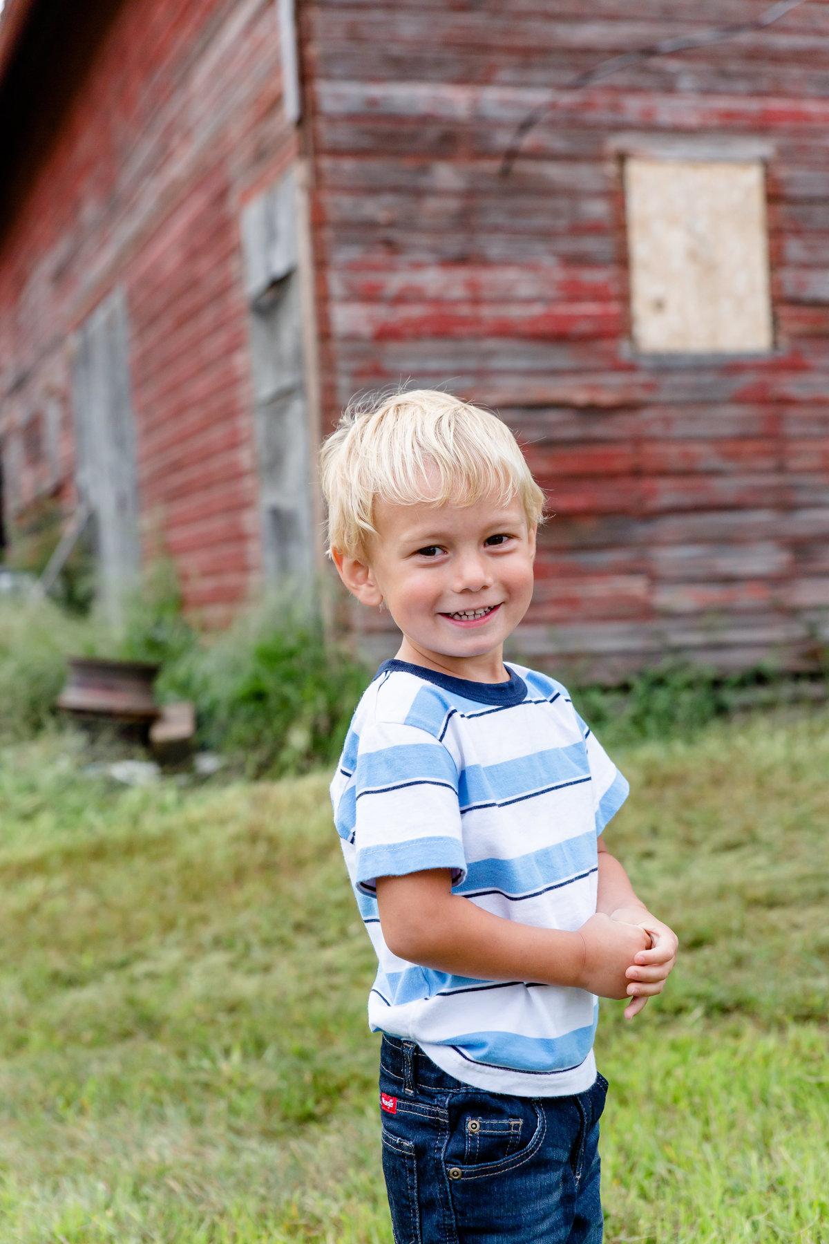 Child in front of family barn